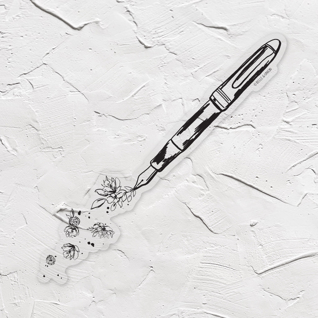 Black and white sticker with image of writing fountain pen with greenery and flowers coming out of tip.