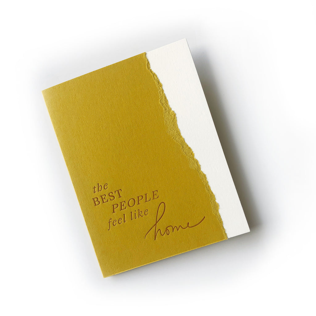 Goldenrod card with white torn edge on right side. Gold text saying, “The Best People Feel Like Home”. A matching envelope is included.