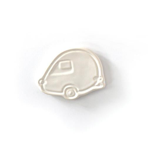 Ivory ceramic with embossed image of a vintage camper.