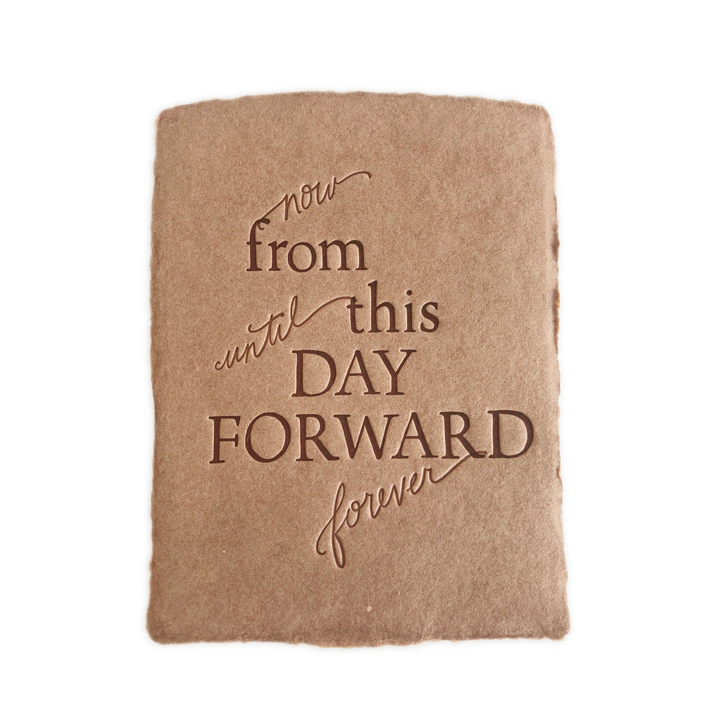 Brown card with torn edge and embossed brown text saying,
