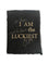 Black card with torn edges and gold foil text saying,