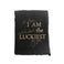Black card with torn edges and gold foil text saying,