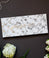 White bookmark with black marble background with gold foil script text saying,