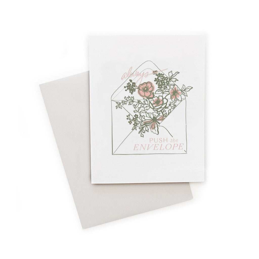 White card with image of a white envelope with pink flowers coming out of the flap with pink text saying, “Always Push the Envelope”. A gray envelope is included.