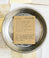 Brown card with black and brown text saying, “Recipe for Mom To Be: hours of morning sickness; quarts of adverse foods; gallons of ice cream; jars of jumbo dill pickles; approved weight gain; one immaculately clean nest; immeasurable glow. Cure at appropriate temp till done, approximately 9 months. Shower with blessings. Deliver when ready.” Image pickles in bottom right corner. A white envelope is included.