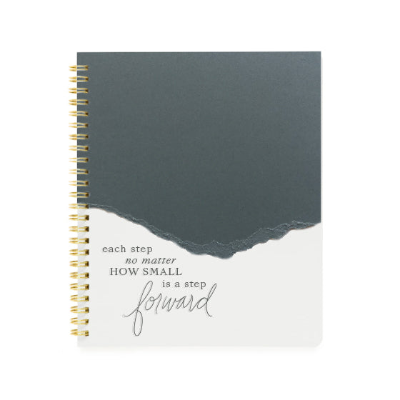 Torn edge notebook with slate gray on top and ivory on the bottom. Gray text saying, “Each Step No Matter How Small Is A Step Forward”. Gold coil binding on left side.