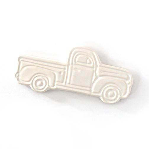Ivory ceramic with embossed image of a vintage pick up truck.