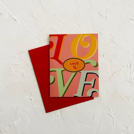 Colorful card with 'LOVE' text on a textured white surface