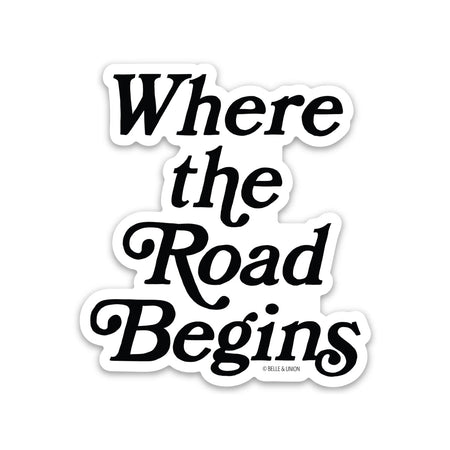 White background with black script text saying, “Where the Road Begins”.